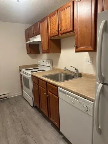 a view of a kitchen with sink and refrigerator