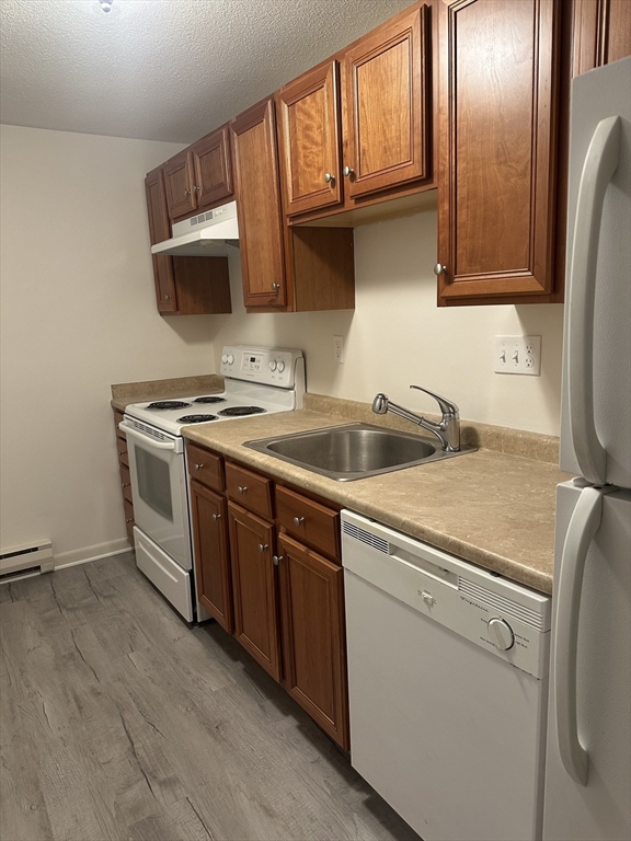 200 Manning Street, Unit 6C Hudson, MA 01749 - Photo 2 of 6 a view of a kitchen with sink and refrigerator