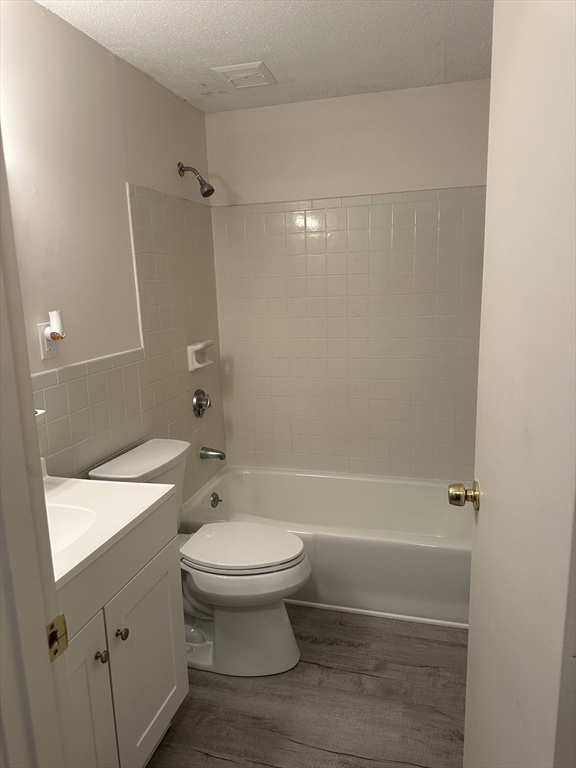 200 Manning Street, Unit 6C Hudson, MA 01749 - Photo 4 of 6 a bathroom with a sink a toilet and shower