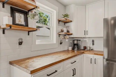 a kitchen with stainless steel appliances granite countertop a sink and a white cabinets