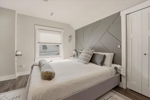 a bedroom with a bed and a window