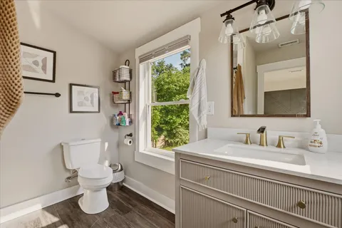 a bathroom with a toilet sink and mirror
