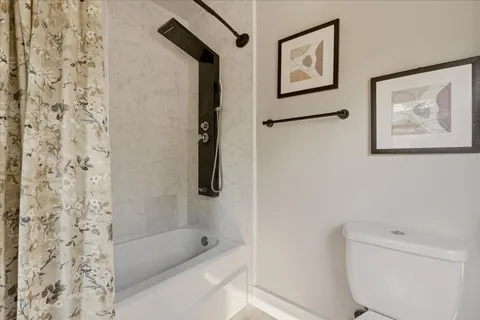 a bathroom with a bathtub and a shower