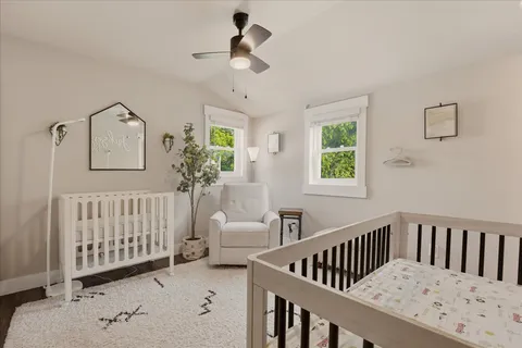 a view of a bedroom with furniture and windows