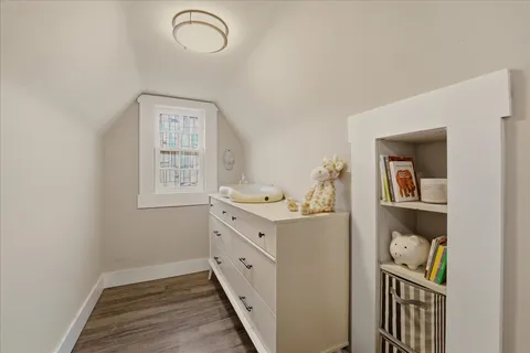 a room with bed and wooden floor