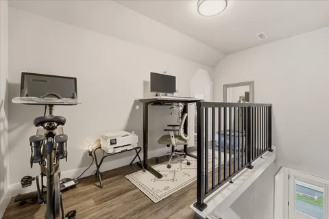 a view of a hallway with workspace and windows
