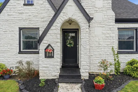 a view of a door of the house with a chair