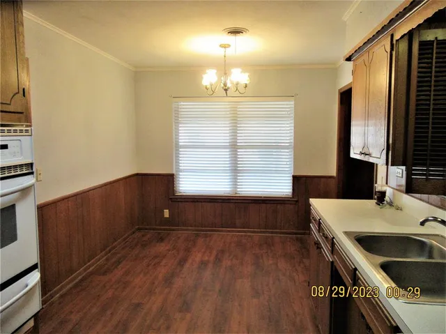a room with a wooden floor and a window