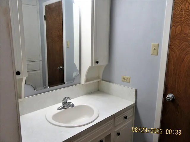 a bathroom with a sink and a mirror