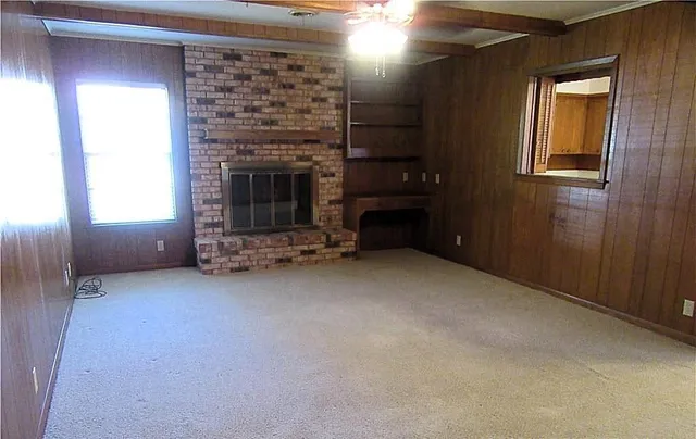 a view of an empty room with a fireplace