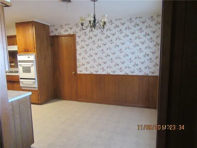 a view of a refrigerator in kitchen and a window