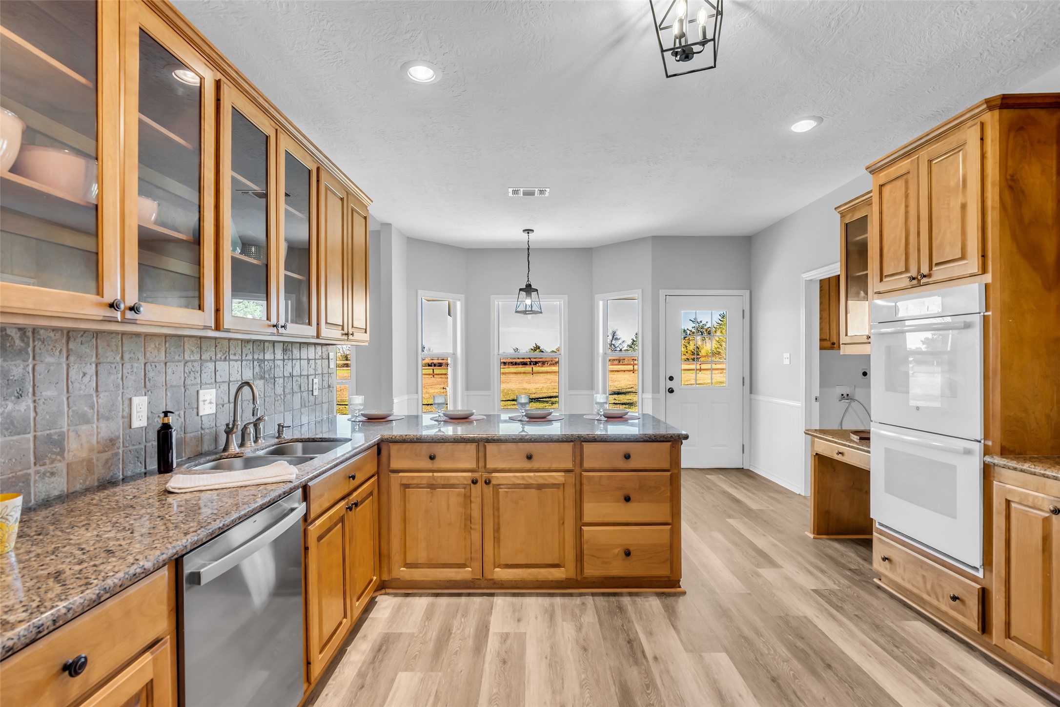 1075 Harrisburg Road Brenham, TX 77833 - Photo 19 of 49 a kitchen with stainless steel appliances granite countertop a sink stove and refrigerator