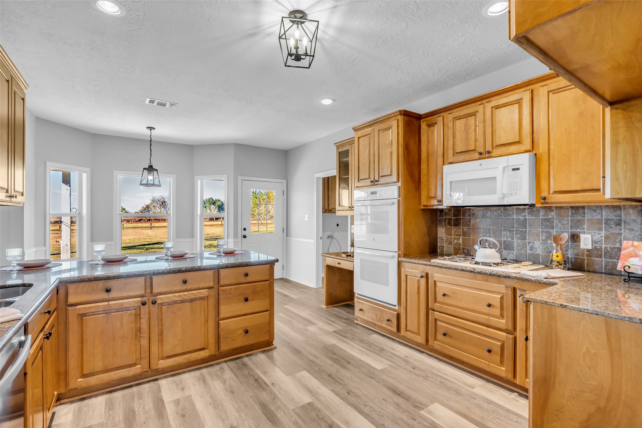 1075 Harrisburg Road Brenham, TX 77833 - Photo 20 of 49 a kitchen with stainless steel appliances granite countertop a stove and a sink
