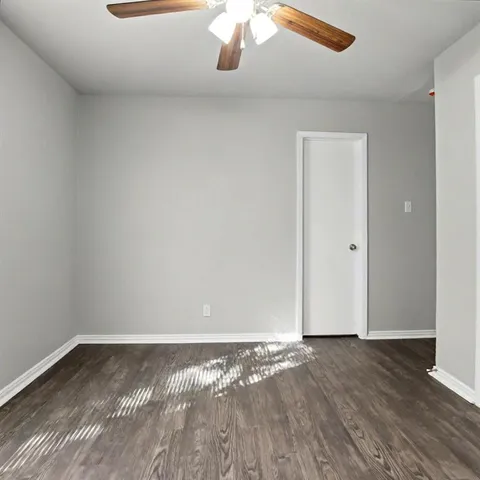 a view of room with wooden floor