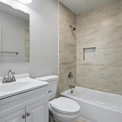 a bathroom with a toilet a sink and a bathtub