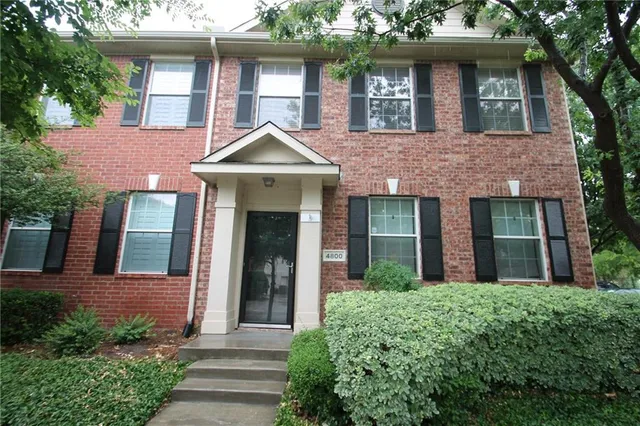 a front view of a house with yard