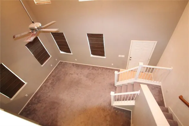 a view of an empty room with windows