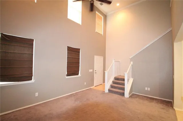 a view of an empty room with a fireplace and a window