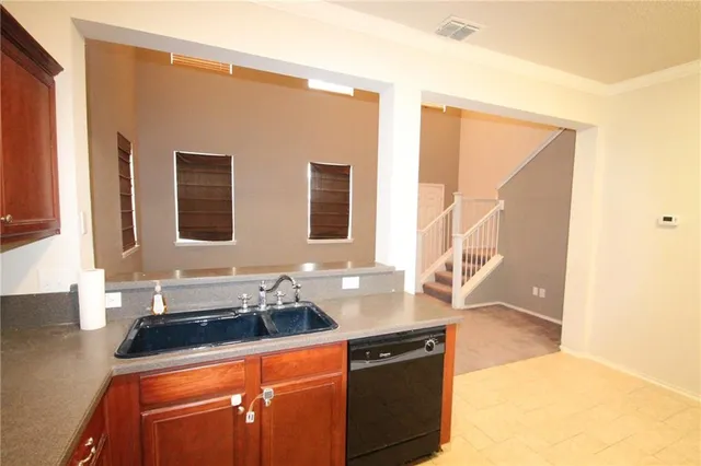 a kitchen with stainless steel appliances granite countertop a sink stove and cabinets