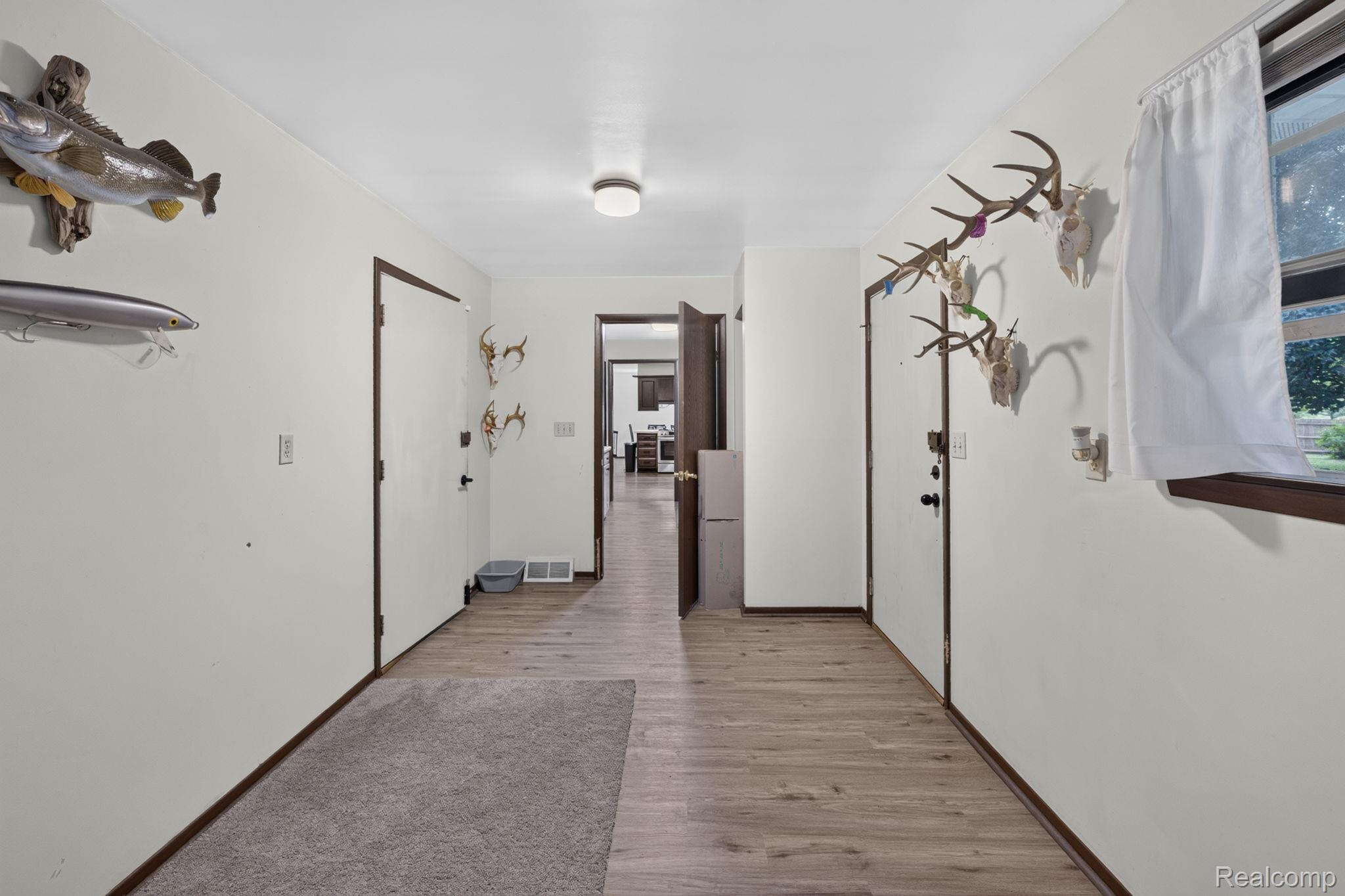 5330 Sheridan Road Saginaw, MI 48601 - Photo 25 of 50 Hallway featuring wood-finish flooring, white walls, and dark trim