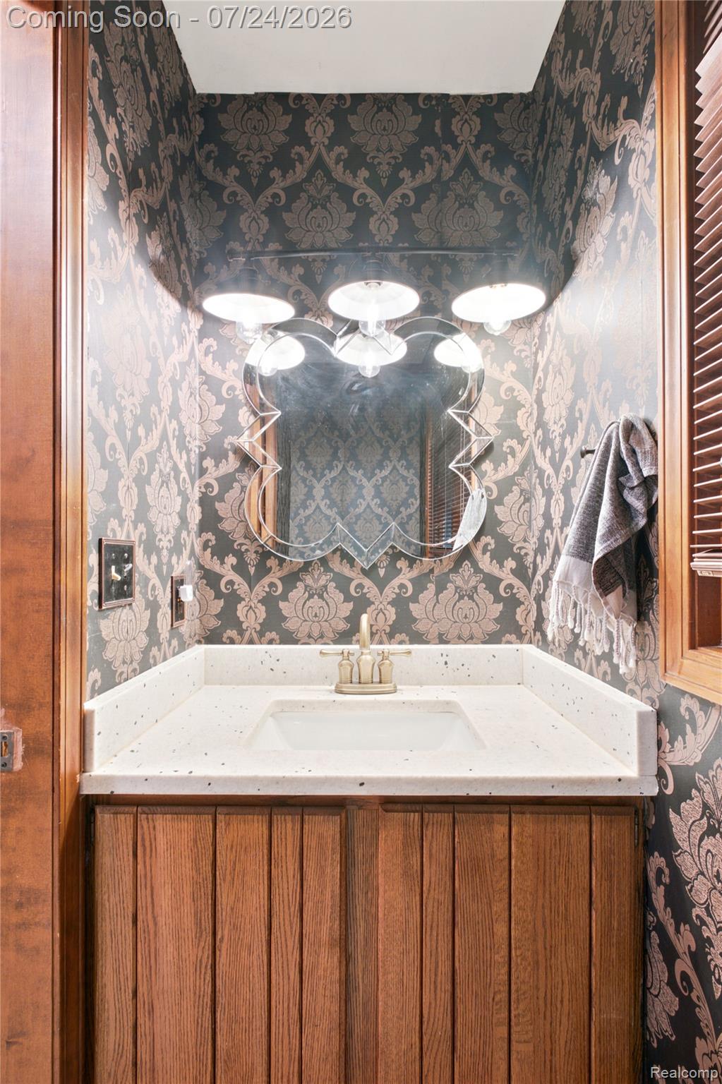 377 Ridgemont Road Oxford, MI 48370 - Photo 21 of 52 Vanity with a white composite countertop, integrated sink, and brushed gold faucet hardware