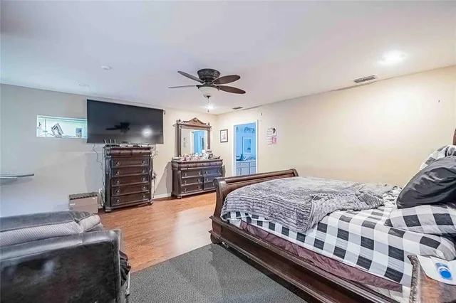 a bedroom with furniture and a wooden floor