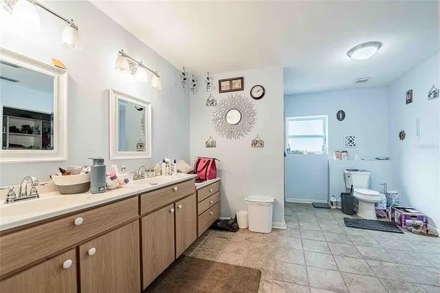 a living room with furniture a flat screen tv and a window