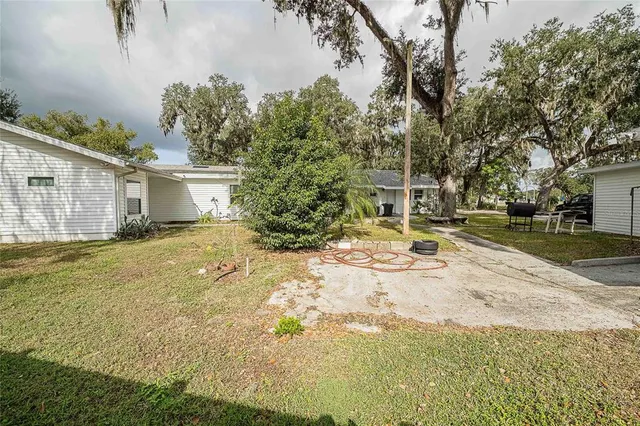 a view of a house with a yard and garage