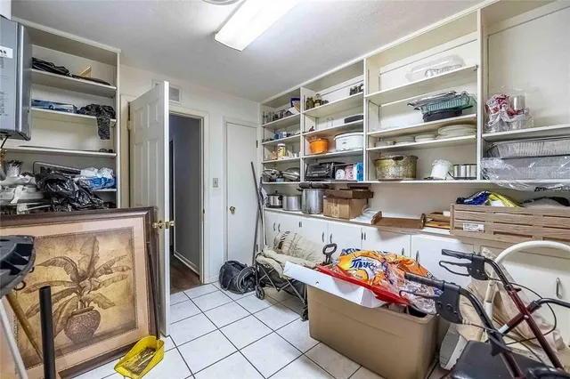 an aerial view of residential house with outdoor space and trees all around