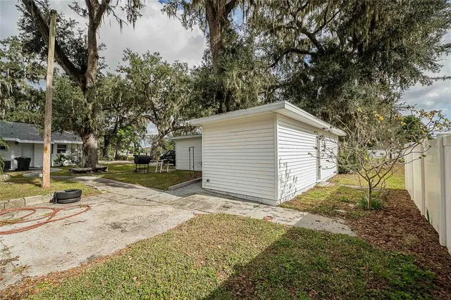 a kitchen with stainless steel appliances granite countertop a refrigerator a sink dishwasher a stove and white countertops with wooden floor
