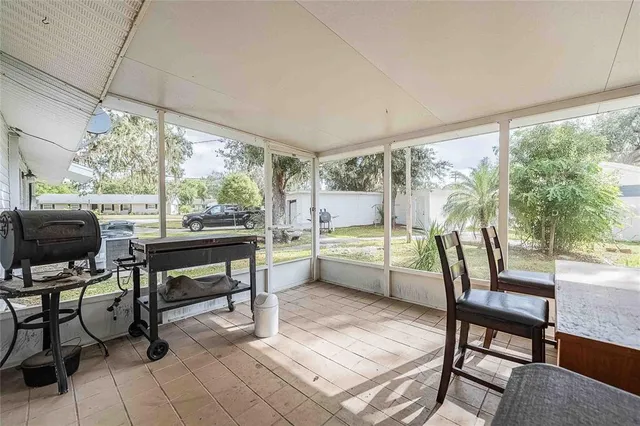 a kitchen with a refrigerator and a wooden floor
