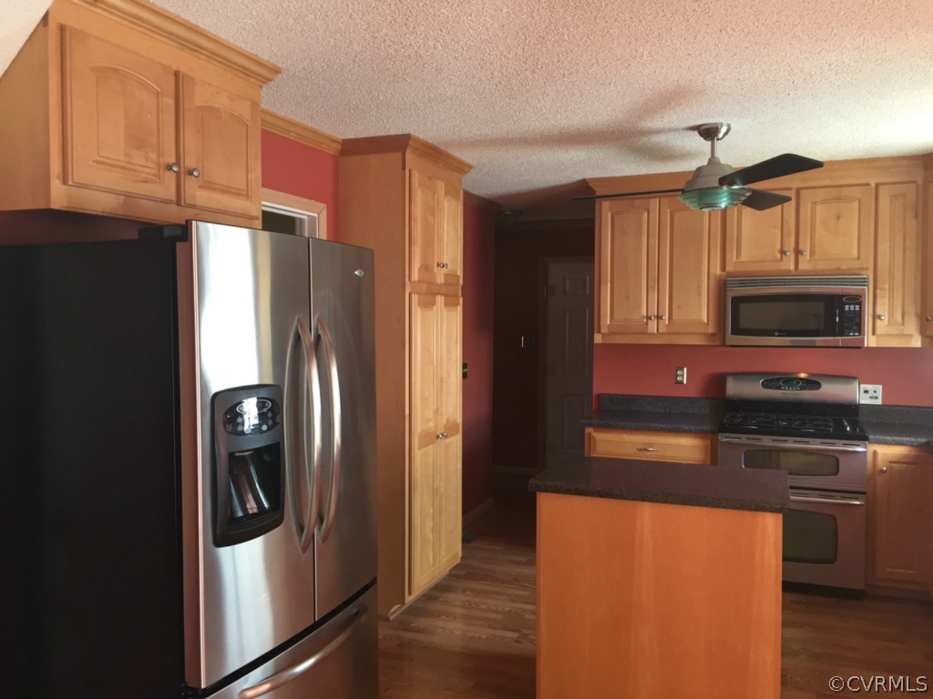 17941 Loving Union Road Disputanta, VA 23842 - Photo 3 of 17 a kitchen with stainless steel appliances granite countertop a refrigerator and a stove top oven