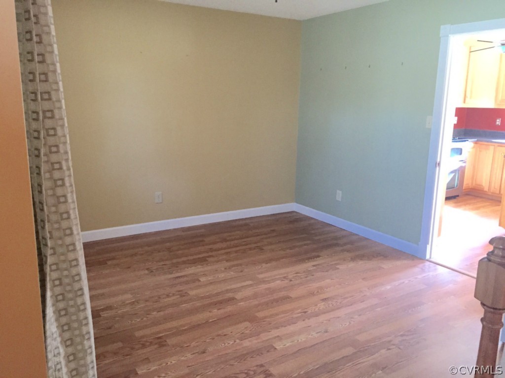 17941 Loving Union Road Disputanta, VA 23842 - Photo 5 of 17 a view of empty room with wooden floor and fan