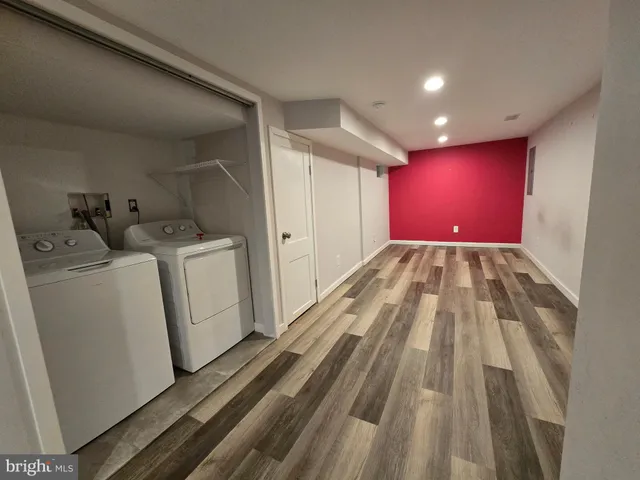 a view of a bedroom with wooden floor and closet