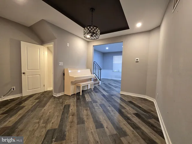 a living room with furniture a window and a wooden floor