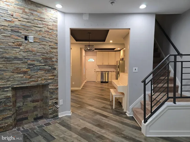 a view of an empty room with window and stairs