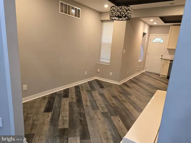 a view of a livingroom with furniture and staircase