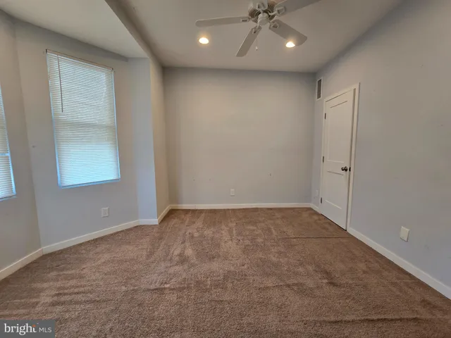 a kitchen with granite countertop a refrigerator stove and microwave