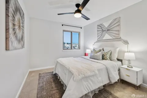 a bedroom with a large bed and a chandelier