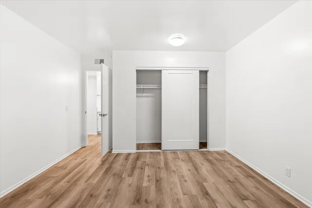 an empty room with wooden floor