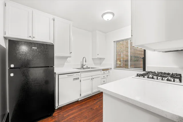 a kitchen with a refrigerator and a stove