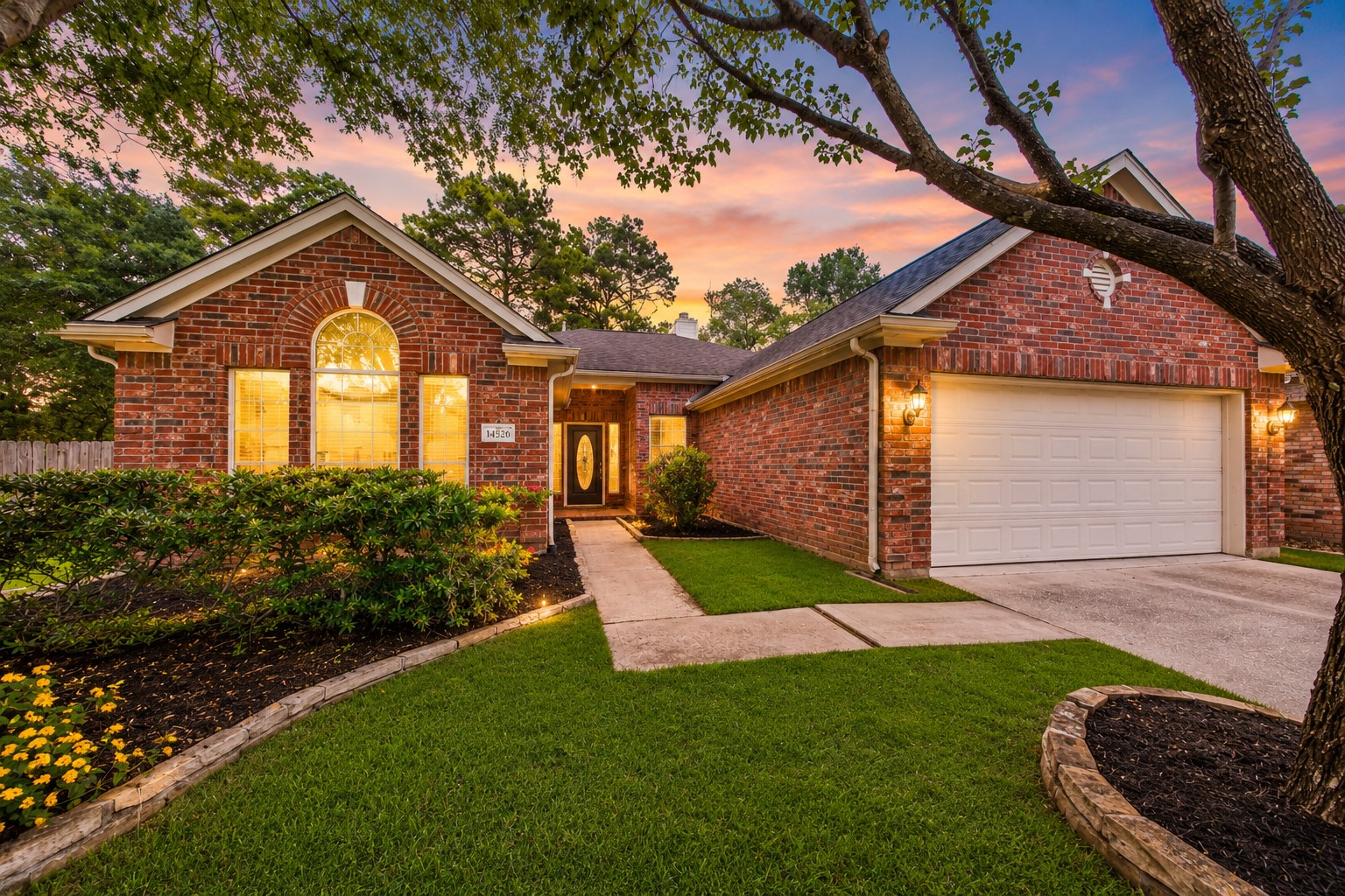 14526 Red Tailed Hawk Lane Houston, TX 77044 - Photo 2 of 40 a view of a house with a small yard plants and a large tree
