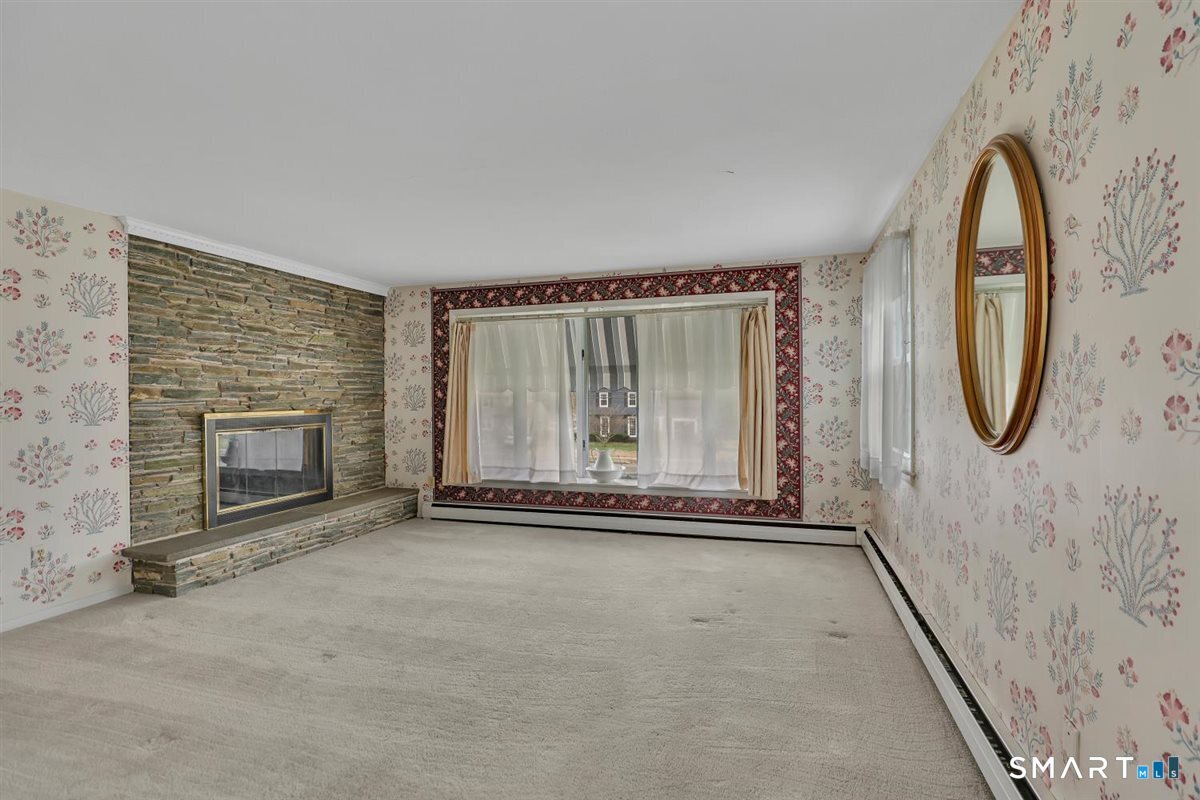 282 Parker Avenue Meriden, CT 06450 - Photo 4 of 27 an empty room with a fireplace and mirror