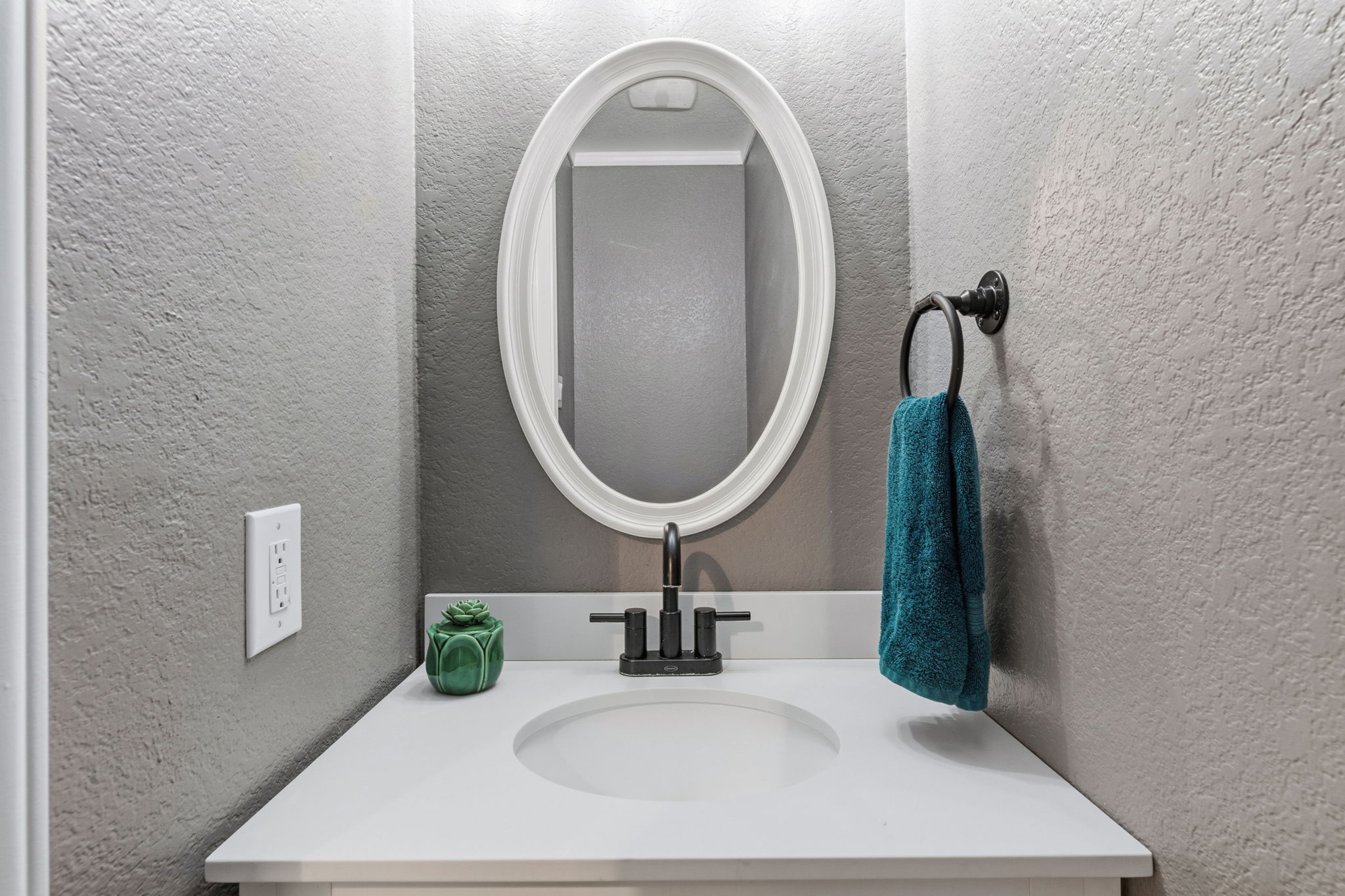 310 Myrtle Street Kyle, TX 78640 - Photo 11 of 39 a bathroom with a sink and a mirror