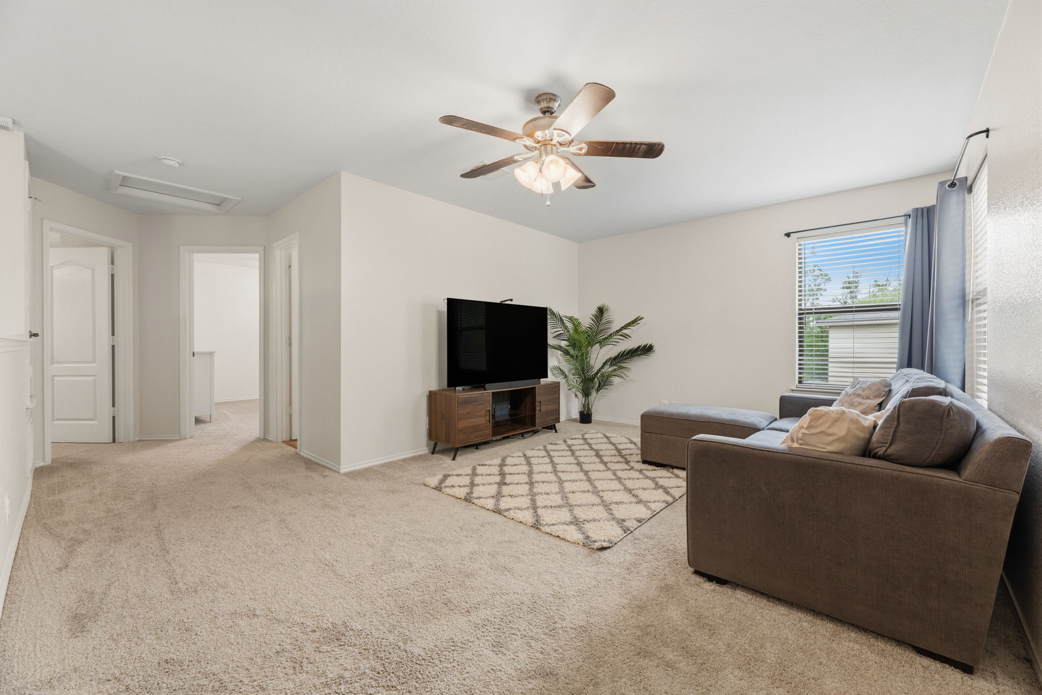 310 Myrtle Street Kyle, TX 78640 - Photo 14 of 39 a living room with furniture and a flat screen tv
