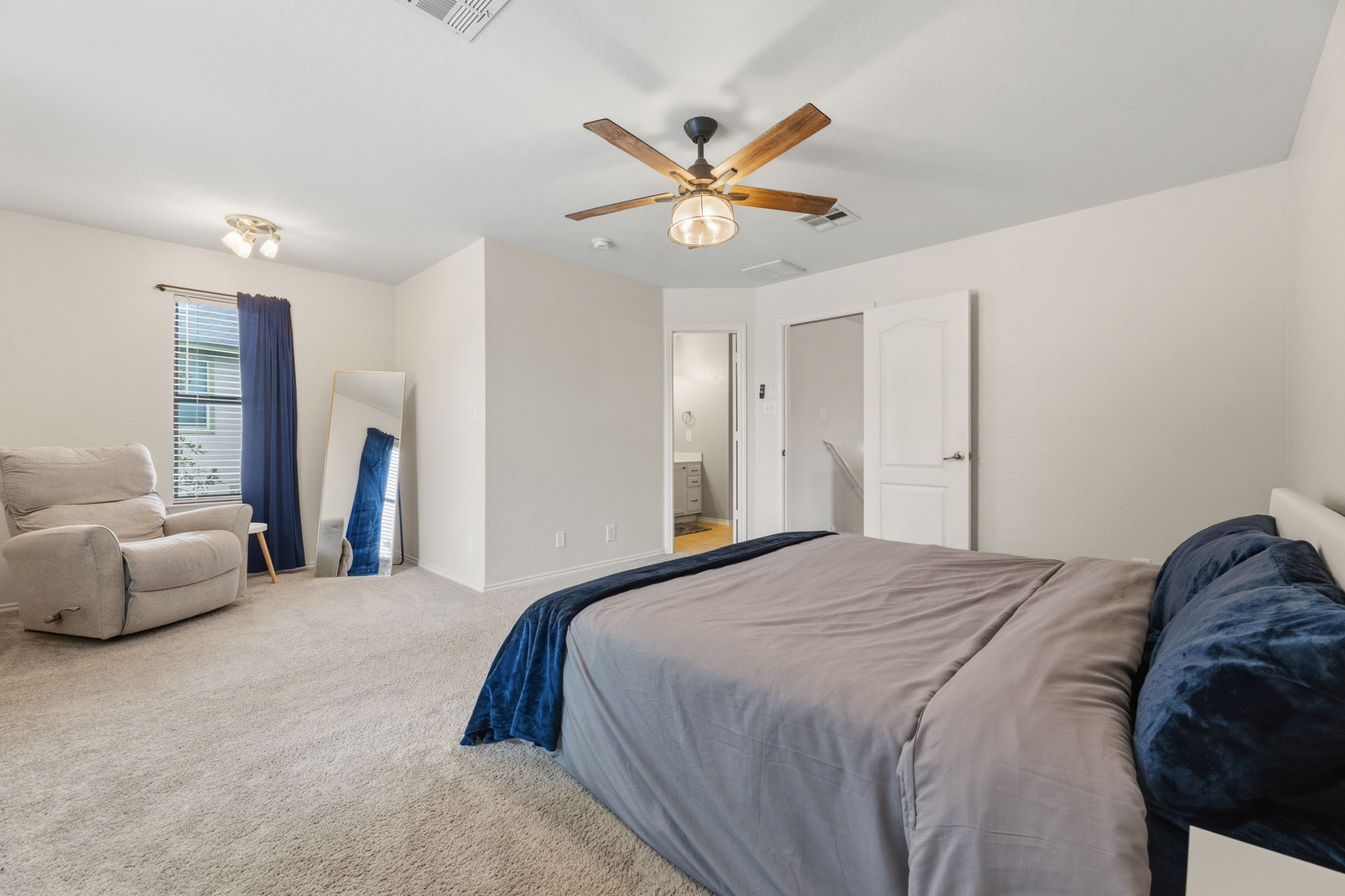 310 Myrtle Street Kyle, TX 78640 - Photo 18 of 39 a bedroom with a bed and ceiling fan