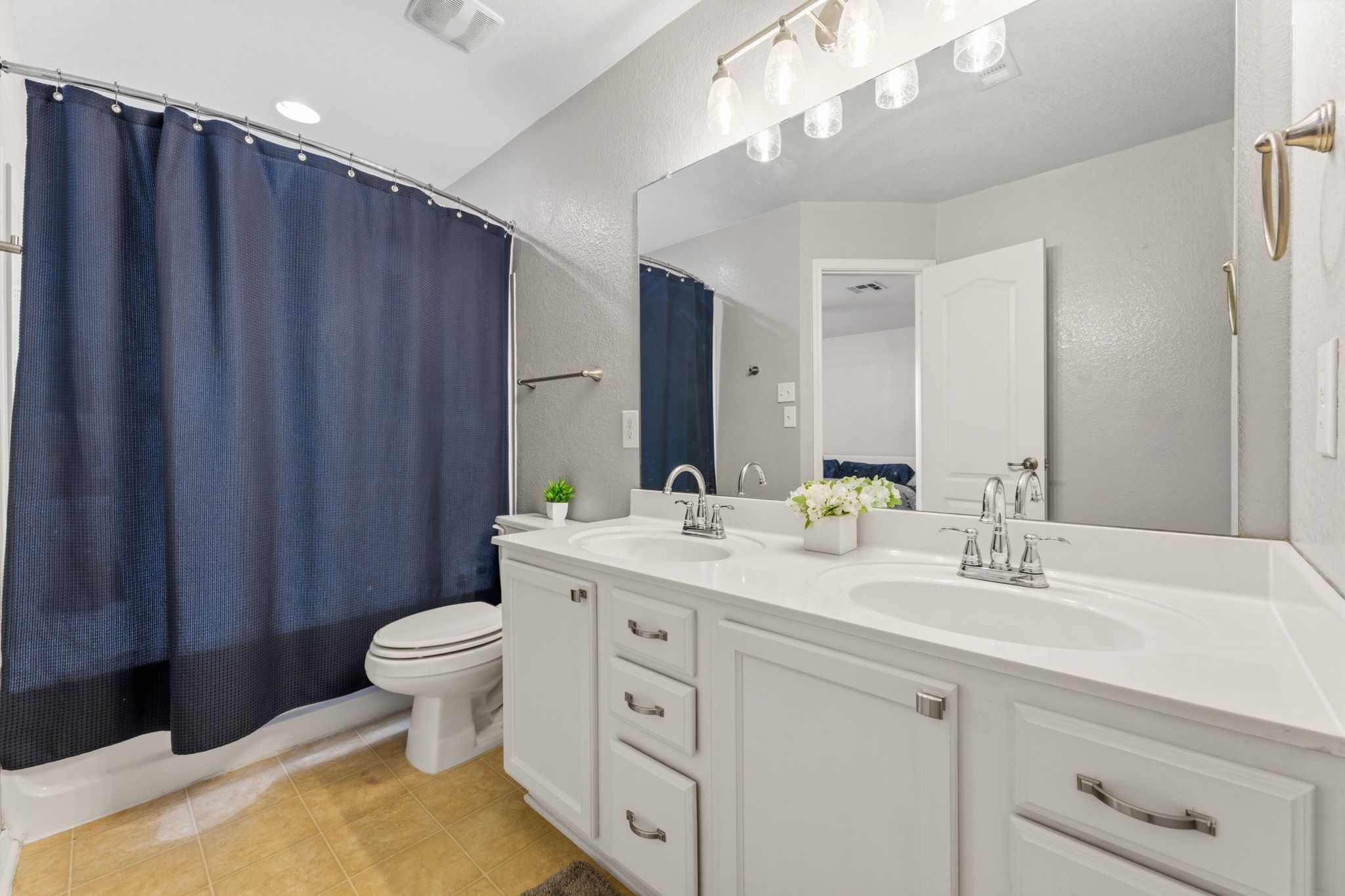 310 Myrtle Street Kyle, TX 78640 - Photo 20 of 39 a bathroom with a double vanity sink toilet and a mirror