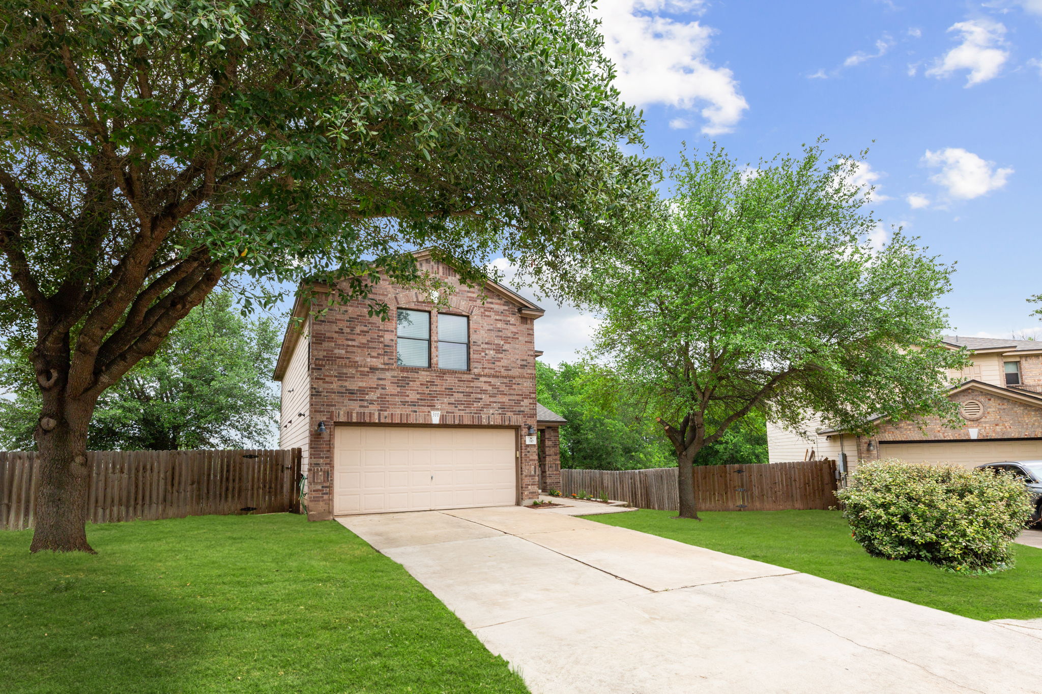 310 Myrtle Street Kyle, TX 78640 - Photo 2 of 39 a front view of a house with a yard and garage