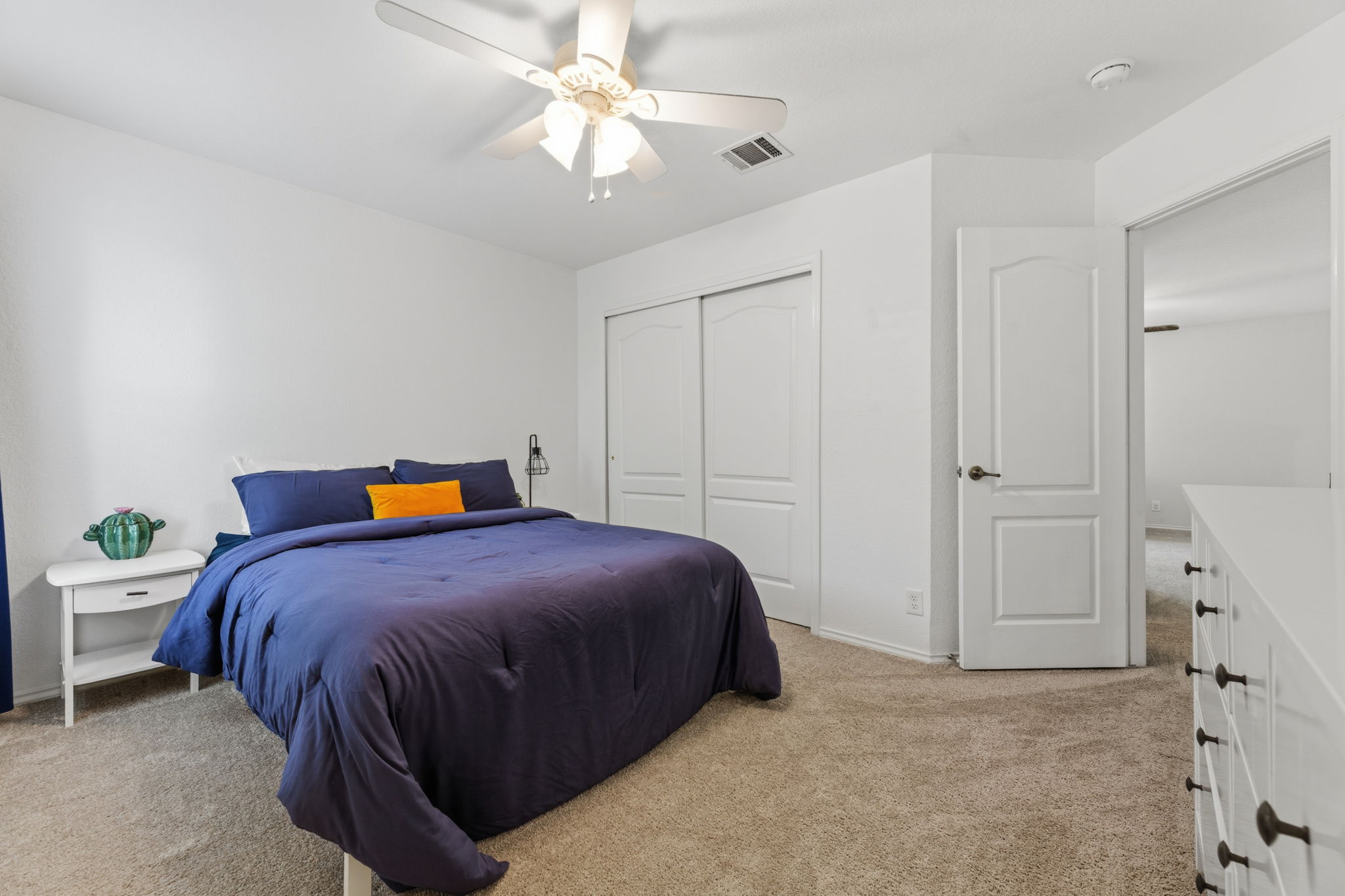 310 Myrtle Street Kyle, TX 78640 - Photo 21 of 39 a bedroom with a bed and a chandelier