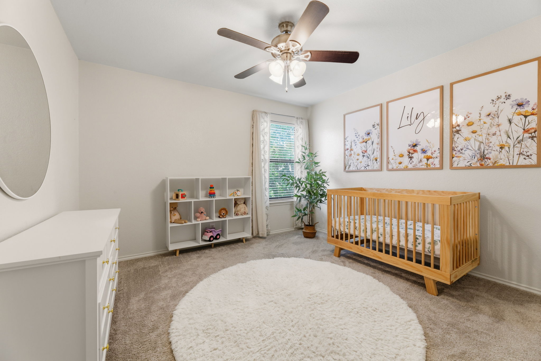 310 Myrtle Street Kyle, TX 78640 - Photo 23 of 39 a view of a bedroom with baby bed and a couch